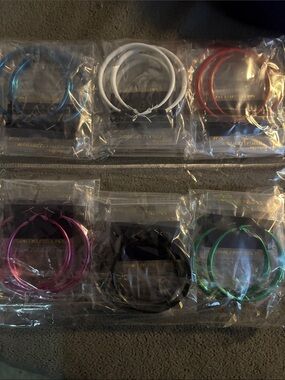 Fashion earrings..12 pk of multicolored hoops ..2 pks of each color shown